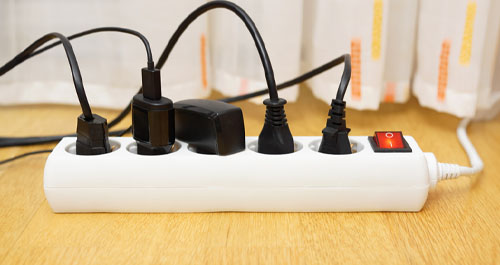 Electrical cords plugged into surge protector