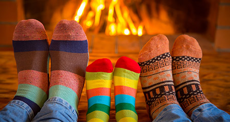 Warming feet with colorful socks at the fireplace