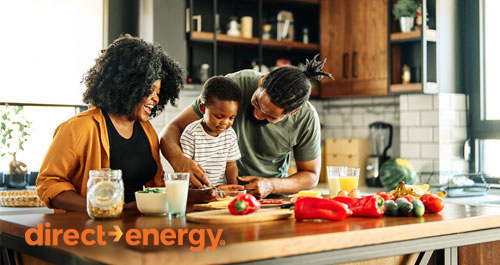 African american family cooking in kitchen laughing