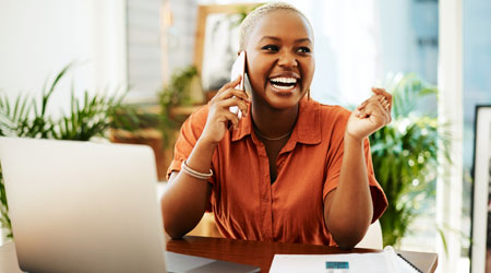 Smiling woman on laptop at home
