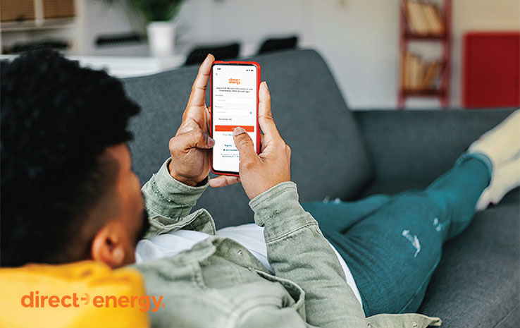 Man on couch using DE app Man on couch using DE app